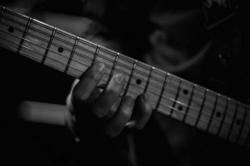 guitar person playing guitar in grayscale photography black-and-white